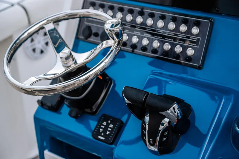 Slide: The Image of 2026 Tidewater 256 LXF boat on trailer at Lakeside Marina, under a clear blue sky. - 21