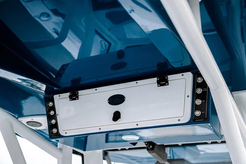 Slide: The Image of 2026 Tidewater 256 LXF boat on trailer with ladder, parked at marina. - 23