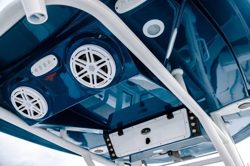 Slide: The Image of 2026 Tidewater 256 LXF boat on trailer in showroom, sleek black design. - 24