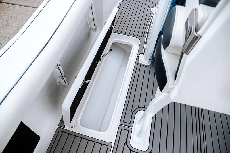 Slide: The Image of 2026 Tidewater 256 LXF boat with dual engines in a showroom. - 27