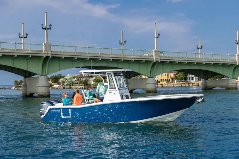 Slide: The Image of 2026 Tidewater 256 LXF boat interior with modern controls and seating in showroom. - 40