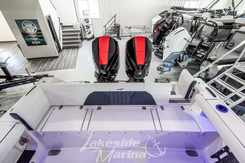 Slide: The Image of 2026 Tidewater 256 LXF boat interior with dual engines at Lakeside Marina showroom. - 44