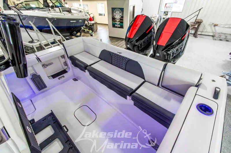 Slide: The Image of 2026 Tidewater 256 LXF boat interior with seating and dual outboard engines at Lakeside Marina. - 46