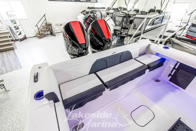 Slide: The Image of 2026 Tidewater 256 LXF boat interior with seating and dual outboard engines at Lakeside Marina. - 47