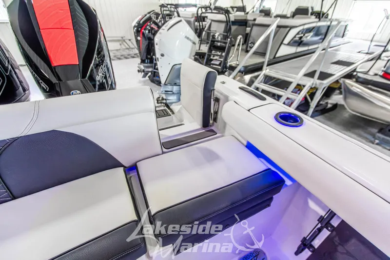 Slide: The Image of 2026 Tidewater 256 LXF boat interior with seating and blue LED lighting. - 48