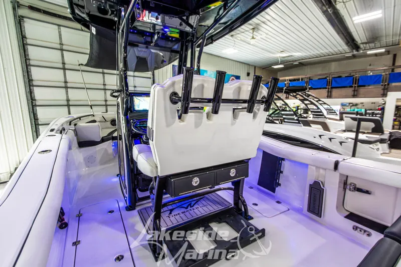 Slide: The Image of 2026 Tidewater 256 LXF boat interior with modern seating and fishing rod holders. - 49