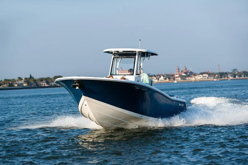 Slide: The Image of 2026 Tidewater 256 LXF boat with dual engines on a scenic river. - 5