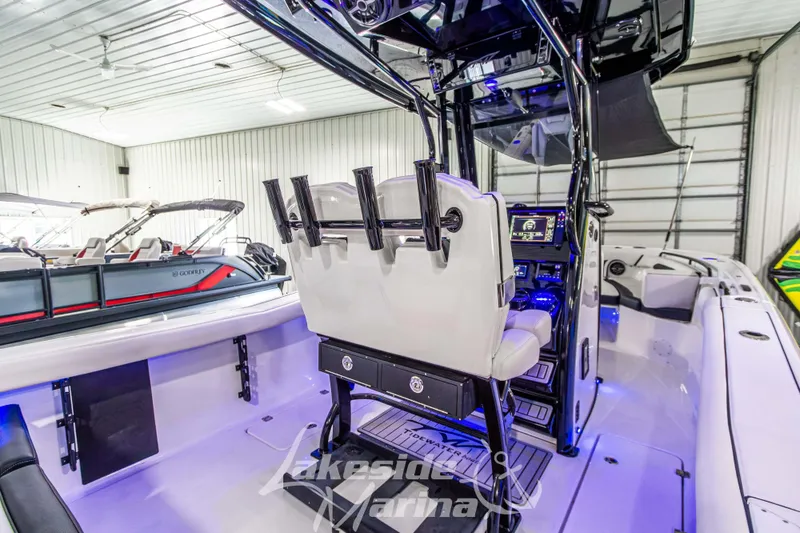 Slide: The Image of 2026 Tidewater 256 LXF boat interior with modern console and seating in a showroom. - 50