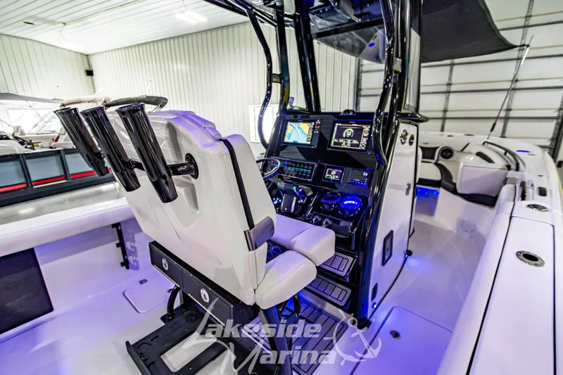 Slide: The Image of 2026 Tidewater 256 LXF boat interior with advanced navigation system and seating. - 54