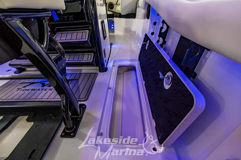 Slide: The Image of 2026 Tidewater 256 LXF boat interior with storage compartment and seating. - 56