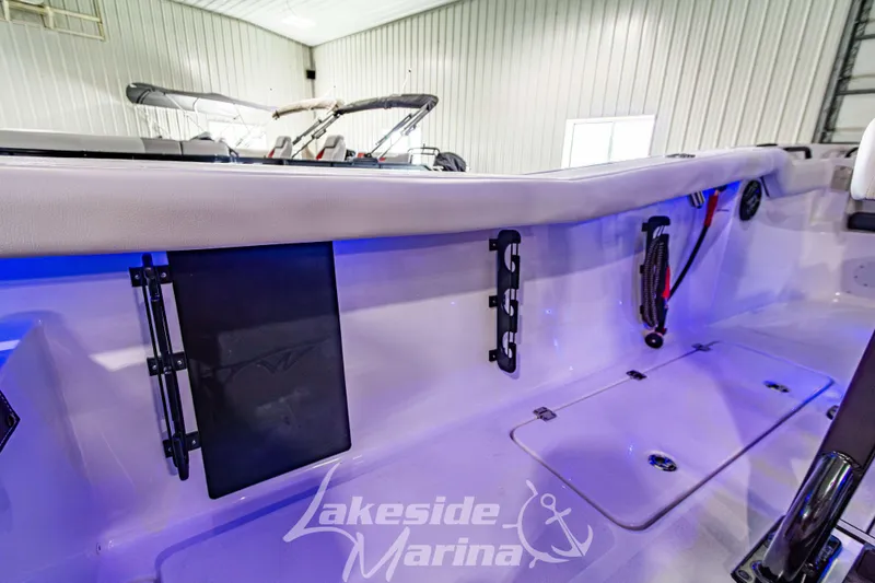 Slide: The Image of 2026 Tidewater 256 LXF boat on water, featuring dual engines and sleek design. - 58