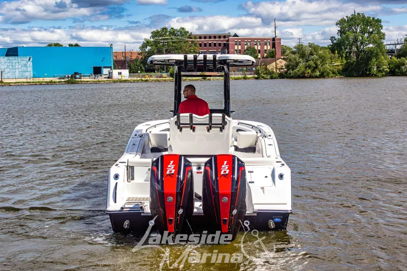 Slide: The Image of 2026 Tidewater 256 LXF boat with dual engines on a scenic river. - 61