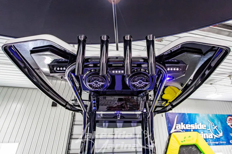 Slide: The Image of 2026 Tidewater 256 LXF boat with advanced audio system and sleek design in a marina setting. - 62