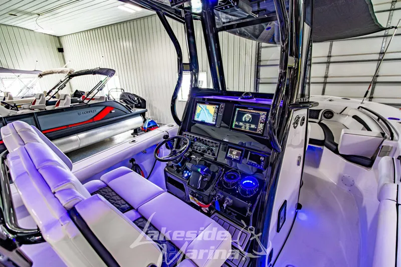 Slide: The Image of 2026 Tidewater 256 LXF boat interior with advanced navigation system and luxurious seating. - 64