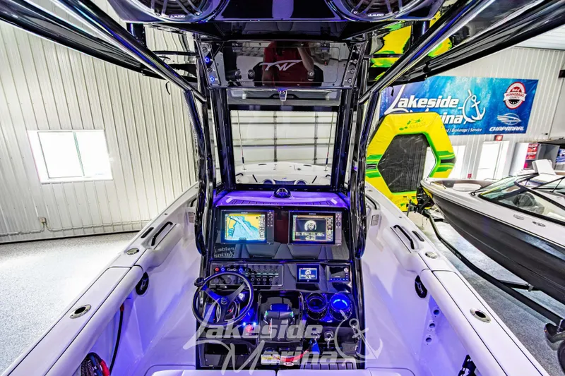 Slide: The Image of 2026 Tidewater 256 LXF boat dashboard with advanced navigation and control systems in showroom. - 65