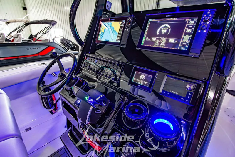 Slide: The Image of 2026 Tidewater 256 LXF boat dashboard with advanced navigation and audio systems. - 71
