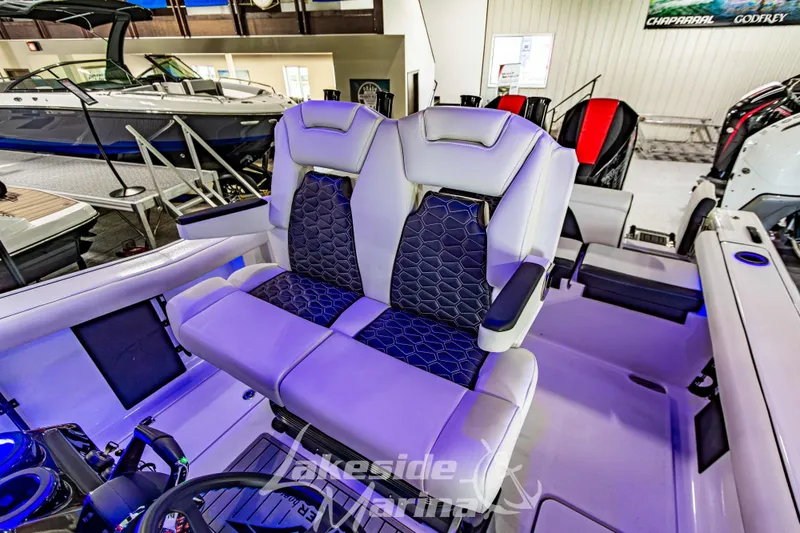 Slide: The Image of 2026 Tidewater 256 LXF boat interior with dual captain's seats in showroom. - 72