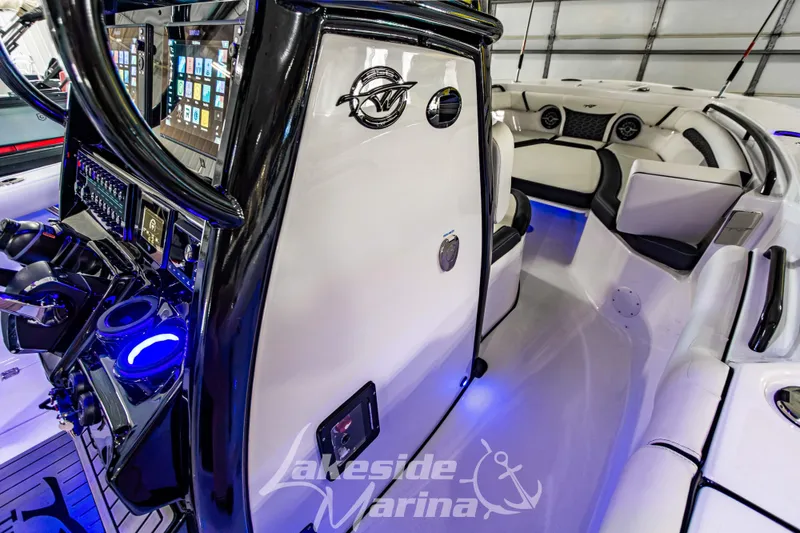 Slide: The Image of 2026 Tidewater 256 LXF boat interior with advanced controls and seating, Lakeside Marina branding. - 76