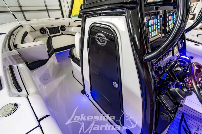 Slide: The Image of 2026 Tidewater 256 LXF boat interior with advanced controls and luxurious seating. - 78