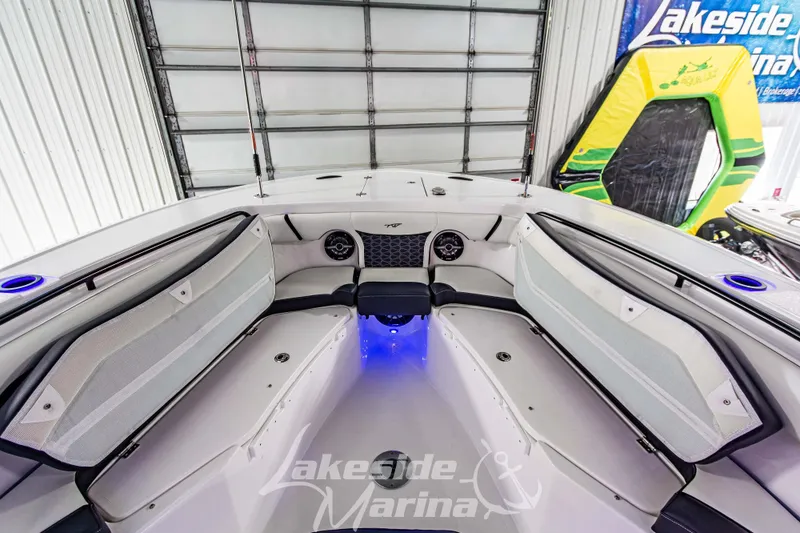 Slide: The Image of 2026 Tidewater 256 LXF boat interior with seating and blue LED lighting. - 90
