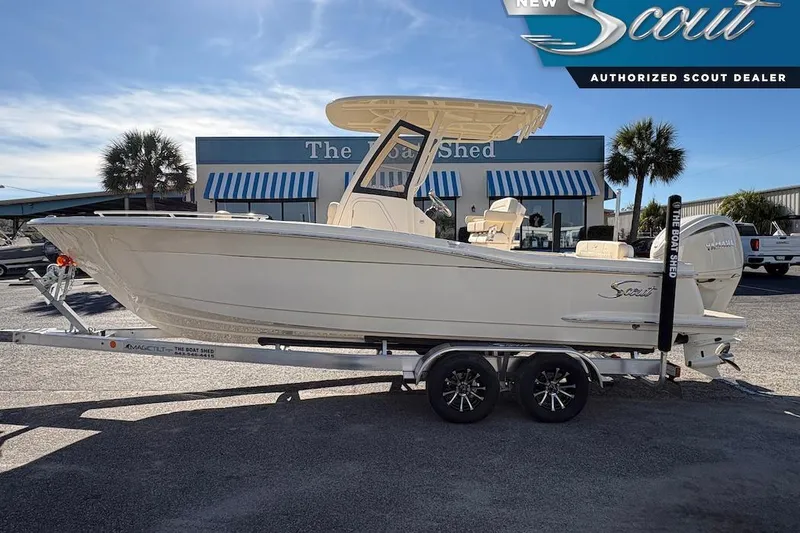 The Image of 2026 Scout 240 XSF boat on trailer at authorized dealer, sunny day. - 0