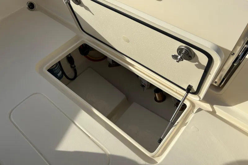 Slide: The Image of 2026 Scout 240 XSF boat seat with beige upholstery and embossed logo. - 10