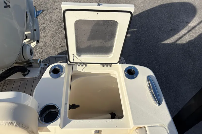 Slide: The Image of Interior view of 2026 Scout 240 XSF boat, featuring a secure latch and warning label. - 12