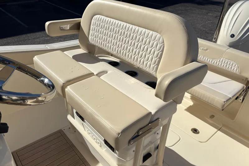 Slide: The Image of 2026 Scout 240 XSF boat interior with beige seating and steering wheel. - 18