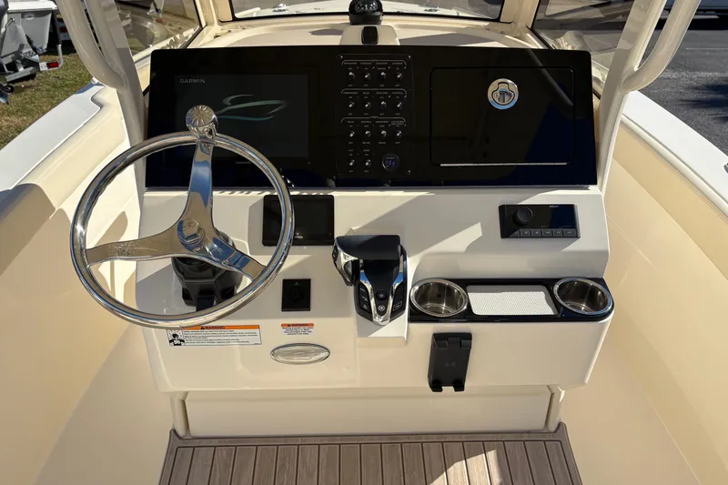 Slide: The Image of 2026 Scout 240 XSF boat dashboard with steering wheel and control panel. - 19