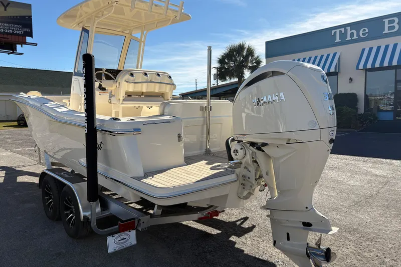 Slide: The Image of 2026 Scout 240 XSF boat with Yamaha 300 V6 engine, parked outdoors. - 2