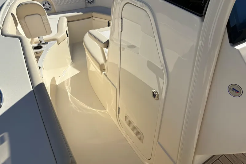Slide: The Image of 2026 Scout 240 XSF boat interior with seating and storage compartments. - 25