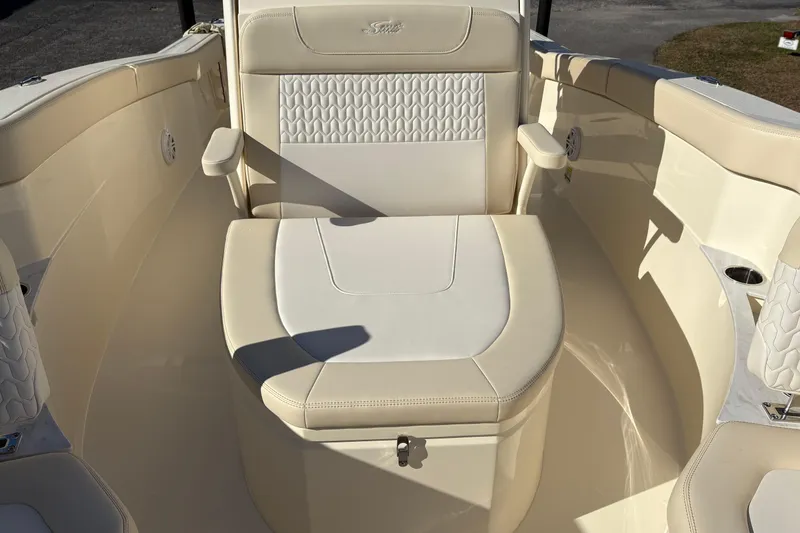 Slide: The Image of 2026 Scout 240 XSF boat interior with beige seating and armrests. - 29