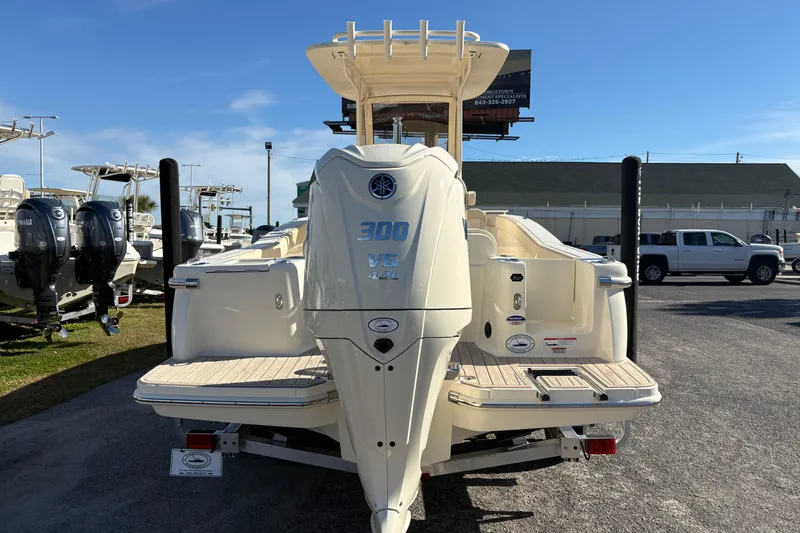 Slide: The Image of 2026 Scout 240 XSF boat with Yamaha engine on trailer, displayed outdoors. - 3