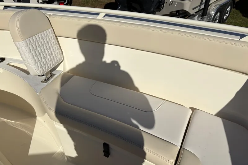Slide: The Image of 2026 Scout 240 XSF boat interior with beige seating and shadow. - 32