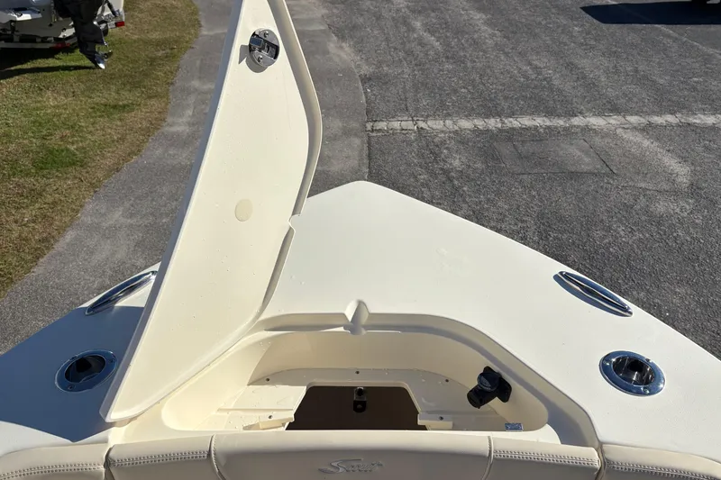 Slide: The Image of 2026 Scout 240 XSF boat with open storage compartment on deck. - 34