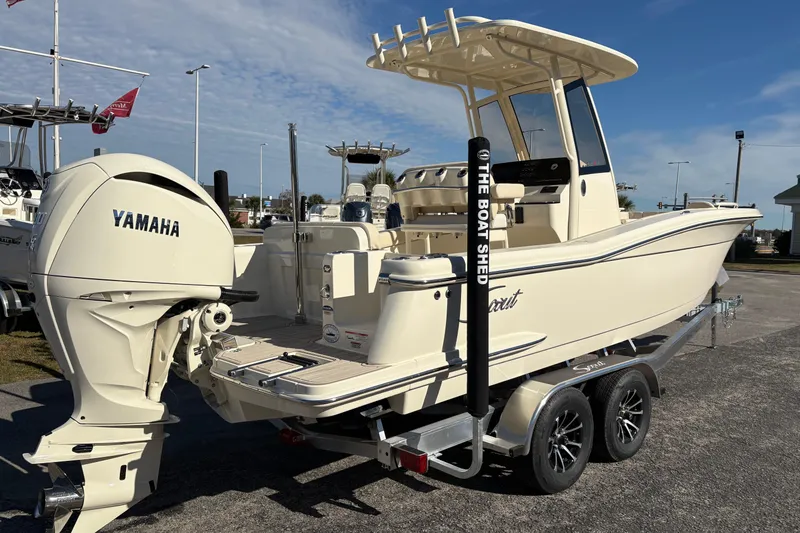 Slide: The Image of 2026 Scout 240 XSF boat on trailer with Yamaha engine, parked outdoors. - 4