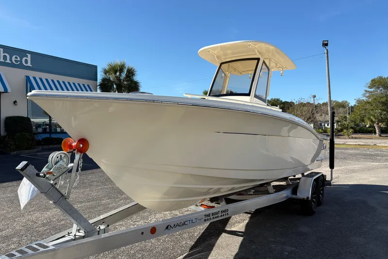 Slide: The Image of 2026 Scout 240 XSF boat interior with beige seating and storage compartments. - 8