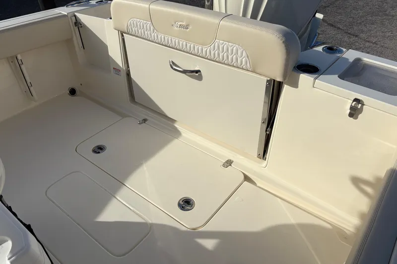 Slide: The Image of Open storage compartment on 2026 Scout 240 XSF boat, showcasing interior details. - 9