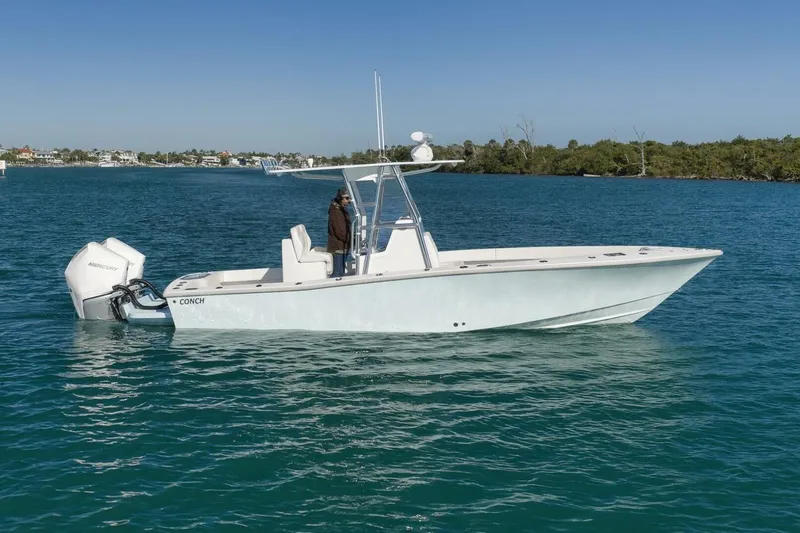 The Image of 2025 Conch 27 boat on clear blue water, featuring a sleek design and powerful Mercury engine. - 1