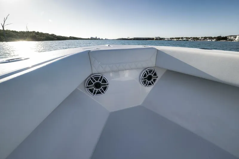 Slide: The Image of Bow of 2025 Conch 27 boat with speakers, on calm water. - 18