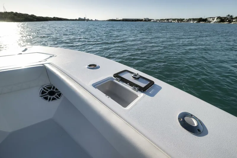 Slide: The Image of 2025 Conch 27 boat deck with open hatch, speaker, and scenic water view. - 21