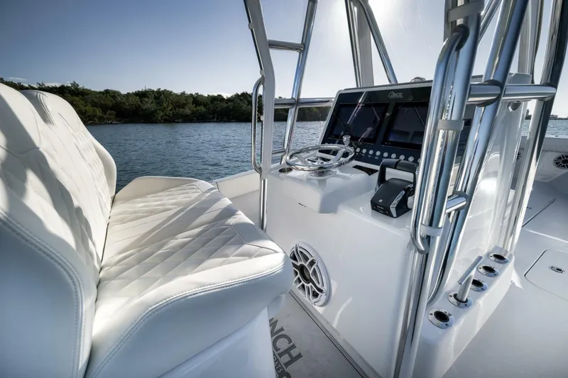 Slide: The Image of 2025 Conch 27 boat interior with sleek white seating and modern control panel. - 28