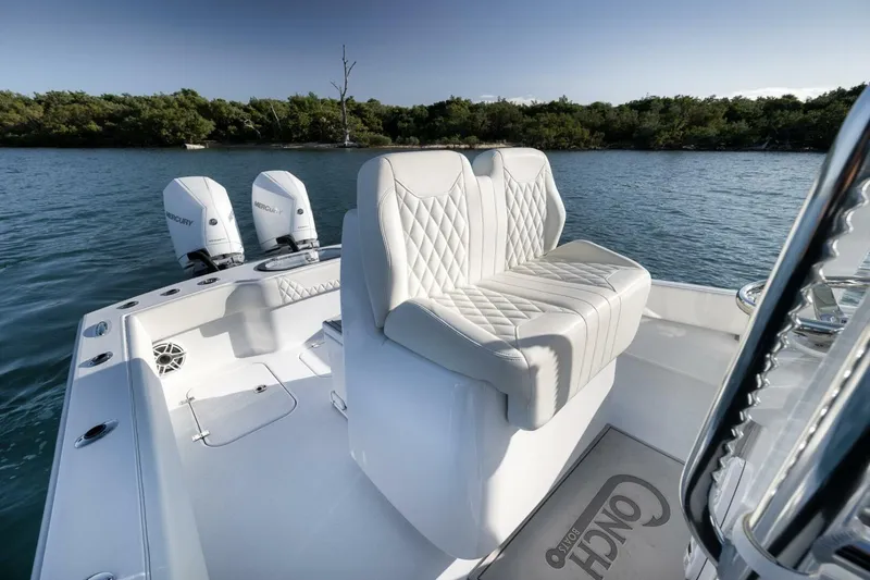 Slide: The Image of 2025 Conch 27 boat with dual Mercury engines and luxurious seating on calm water. - 30