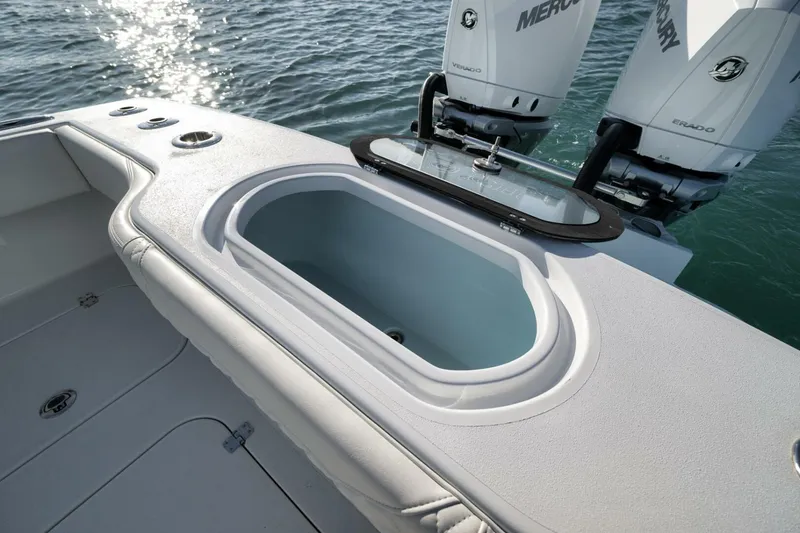 Slide: The Image of 2025 Conch 27 boat with open livewell and dual Mercury engines. - 33