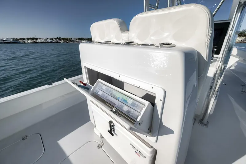 Slide: The Image of 2025 Conch 27 boat with open storage compartment on deck, near marina. - 38