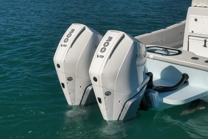 Slide: The Image of Twin Mercury 300 V8 engines on a 2025 Conch 27 boat in clear water. - 40