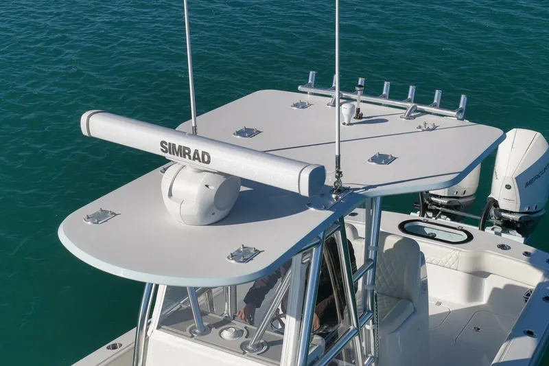 Slide: The Image of 2025 Conch 27 boat with Simrad radar, dual Mercury engines, and sleek design on blue water. - 41