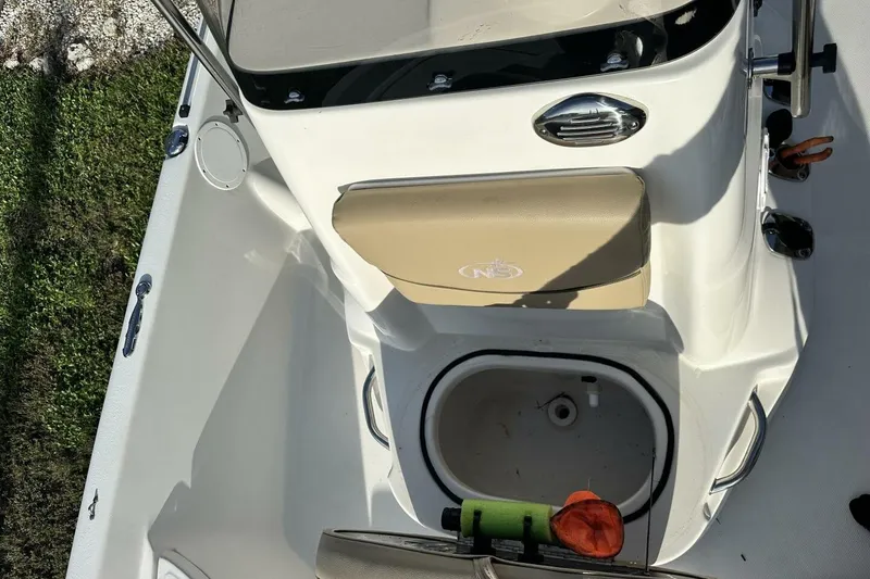 Slide: The Image of 2020 NauticStar 2140 Sport Shallow Bay boat interior with seating and storage. - 12