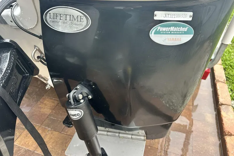 Slide: The Image of 2020 NauticStar 2140 Sport Shallow Bay boat with warranty badges and hydraulic system. - 14