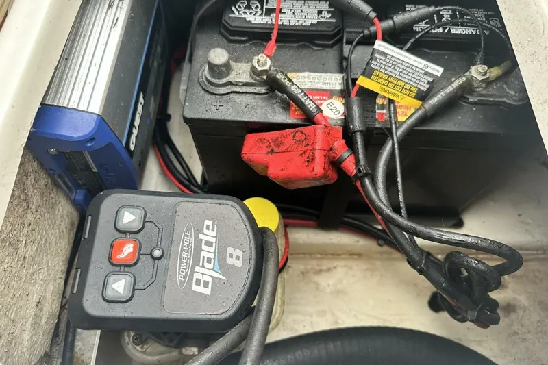 Slide: The Image of Battery compartment of 2020 NauticStar 2140 Sport Shallow Bay boat with wiring and controls. - 19